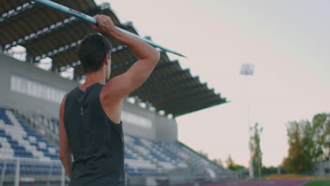 Slow-motion:-a-Male-athlete-at-the-stadium-concentrates-runs-up-and-throws-a-javelin.-Preparation-for-the-Olympic-games-all-around